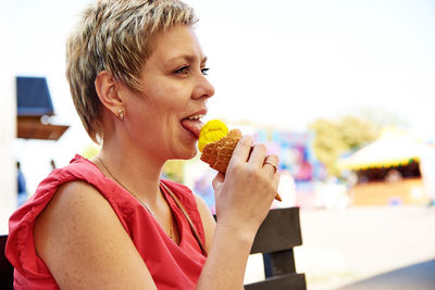 Close-up of smiling man eating ice cream