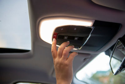 Hand push sos button on ceiling console in modern car