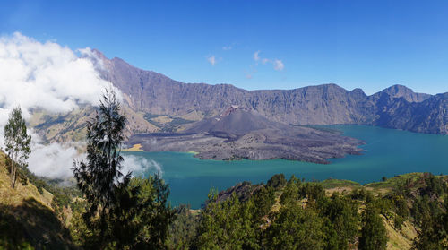 Scenic view of mountain range against blue sky