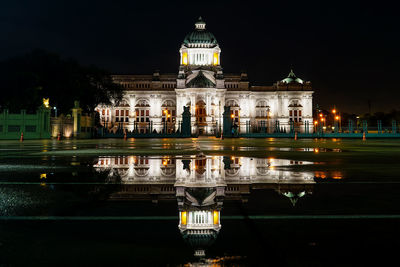 Reflection of building in water at night