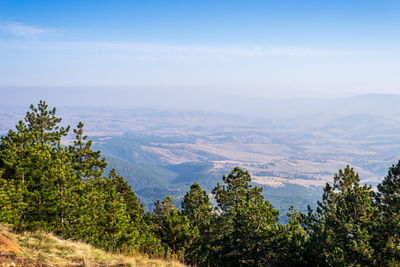 Landscape of hills and valleys on a hazy sunny autumn day