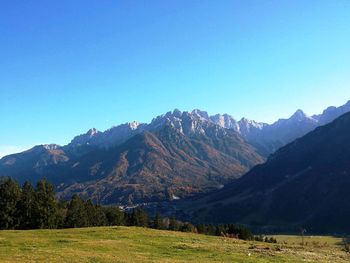 Scenic view of mountains against blue sky