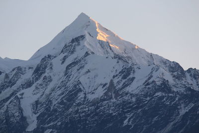 Scenic view of snowcapped mountains against clear sky