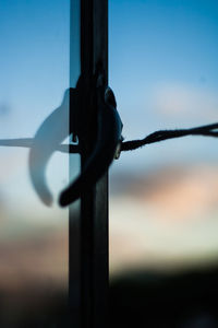 Close-up of metal against sky