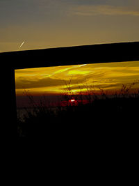 Silhouette landscape against sky during sunset