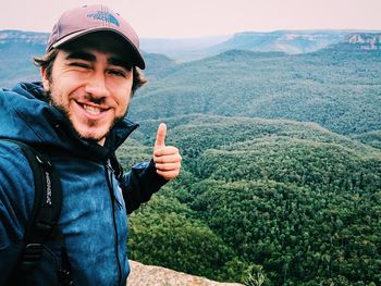 Portrait of smiling man standing at camera