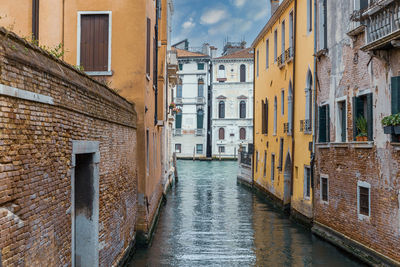 Canal amidst buildings in city