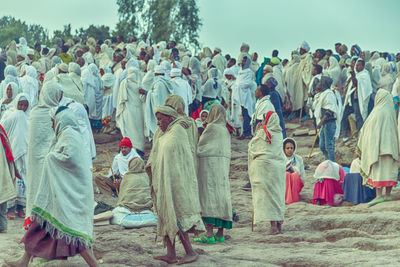 People on land against tree