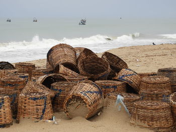 Stack of firewood on sand at beach