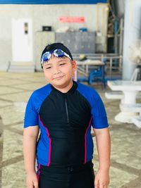 Portrait of smiling boy standing outdoors