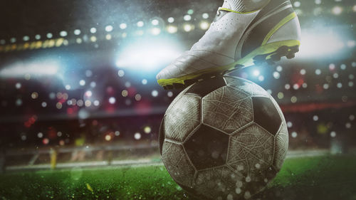 Close-up of soccer ball on field at night