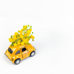 Close-up of yellow toy car against white background