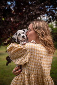 Young woman with a dalmatian puppy