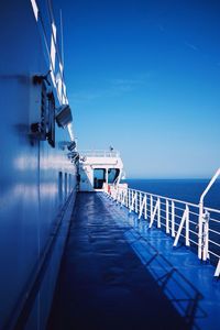 View of empty walkway along sea