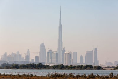 View of buildings in city against clear sky