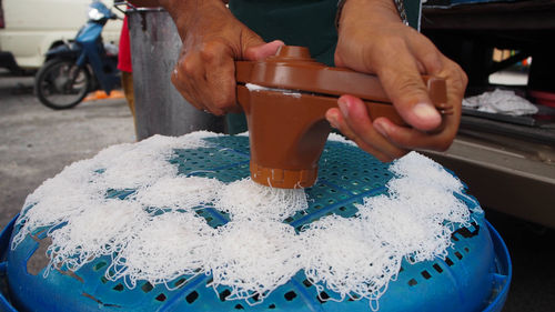 Close-up of man preparing food