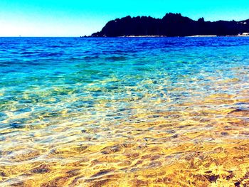 Scenic view of sea against clear blue sky