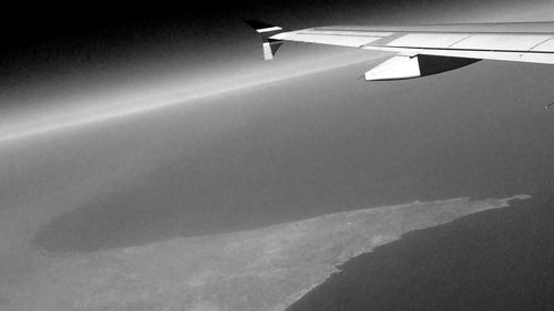 Cropped image of airplane flying over landscape