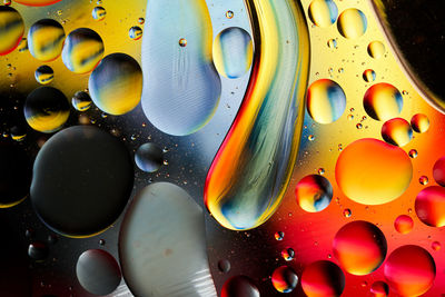 Full frame shot of multi colored water drops and oil