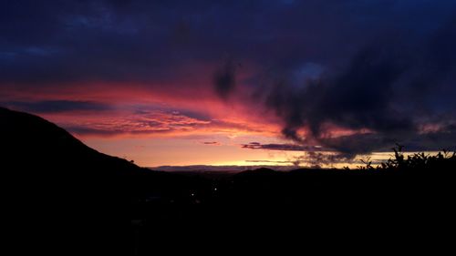 Scenic view of silhouette mountains against sky during sunset