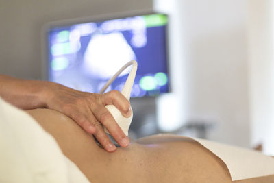 Cropped image of doctor examining patient at hospital