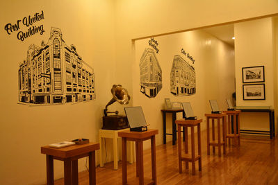 Man and woman standing on table against wall in museum