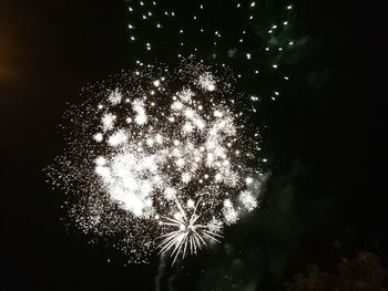 Low angle view of firework display at night