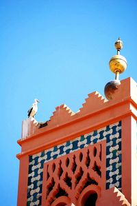 Low angle view of built structure against clear blue sky