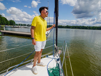 Rear view of man standing in boat