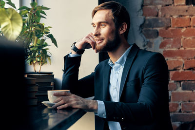 Side view of man drinking coffee