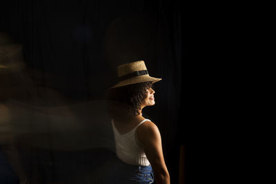 Time-lapse view of woman moving a hat. long exposure, motion blur. happy woman. salvador, brazil.