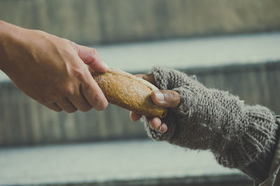 Cropped hands holding bread