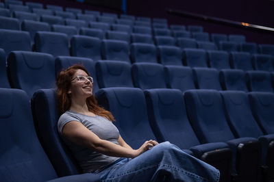 Smiling woman watching movie at theater