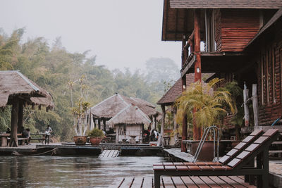 Houses by swimming pool against buildings