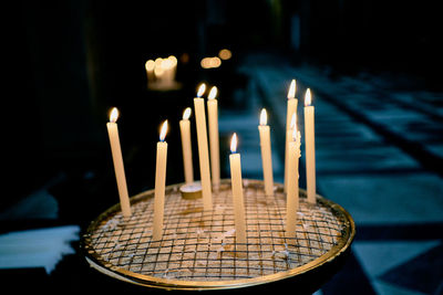 Close-up of burning candles in temple