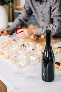 Midsection of man holding wineglass