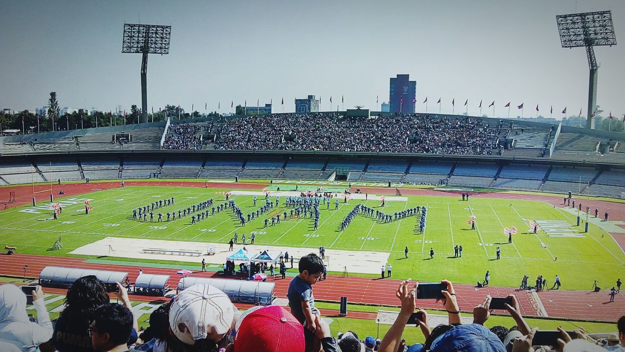 large group of people, real people, stadium, text, sport, men, crowd, architecture, day, women, lifestyles, soccer, spectator, built structure, outdoors, city, fan - enthusiast, sky, people, adult