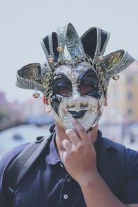 Portrait of man wearing venetian mask