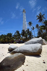 Rock formation on beach against sky