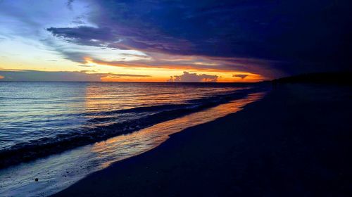 Scenic view of beach against sky during sunset