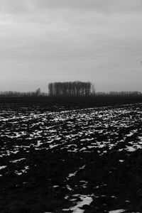 Scenic view of field against cloudy sky