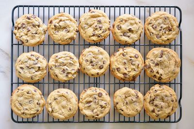 Directly above shot of chocolate chip cookies on cooling rack at table