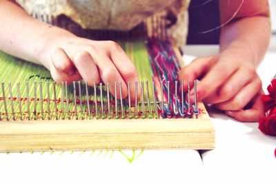 Cropped image of woman weaving