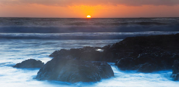 Scenic view of sea against sky during sunset