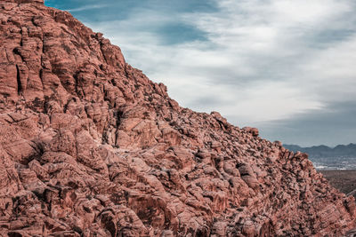 Low angle view of rock formation against sky