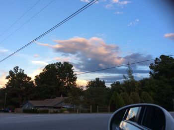 Empty road against cloudy sky