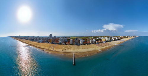 Jesolo in a aerialial panoramic view on blue sea - golden beach and sea with  back city