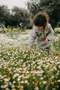 Close-up of girl standing amidst plant