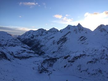 Scenic view of snow covered mountains against sky