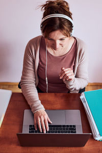 High angle view of woman using laptop at home